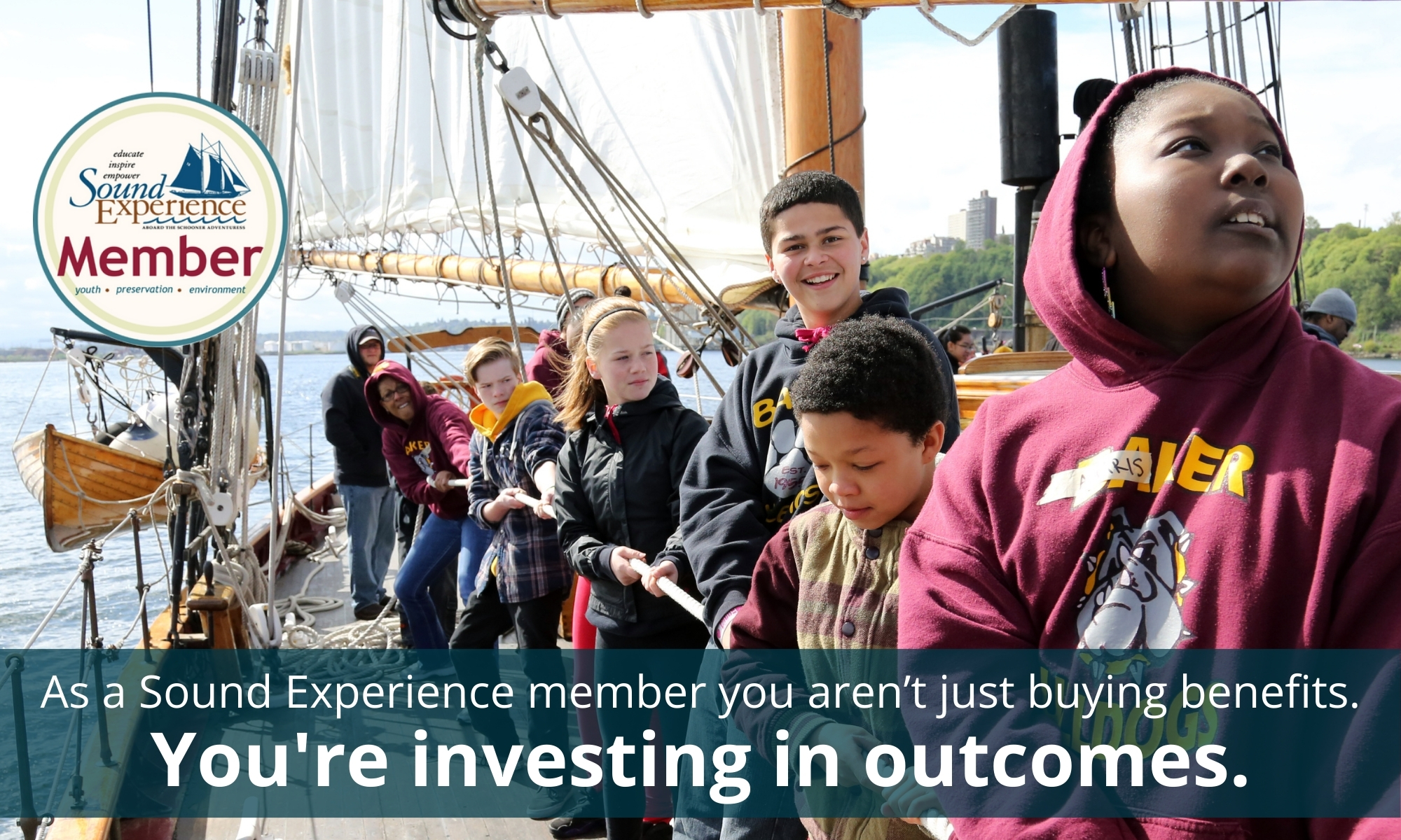 Youth aboard the historic schooner Adventuress grab a line and raise the mainsail in Seattle, WA.